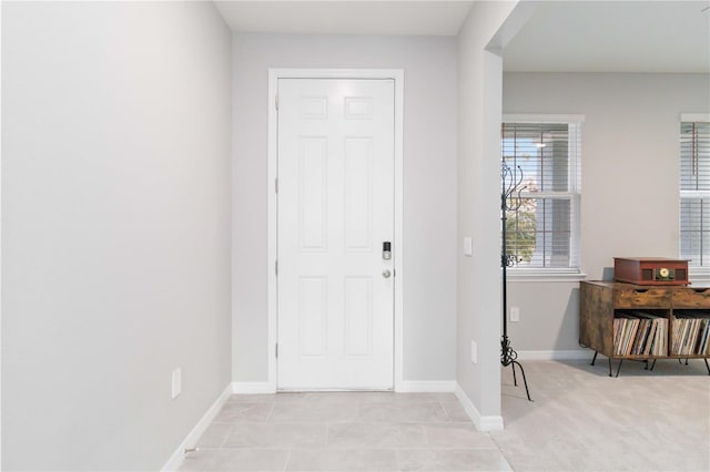 view of carpeted foyer entrance