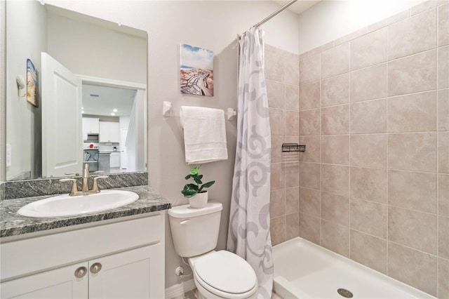 bathroom with vanity, toilet, and walk in shower