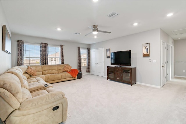 carpeted living room with ceiling fan