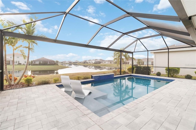 view of pool with a lanai, a water view, and a patio