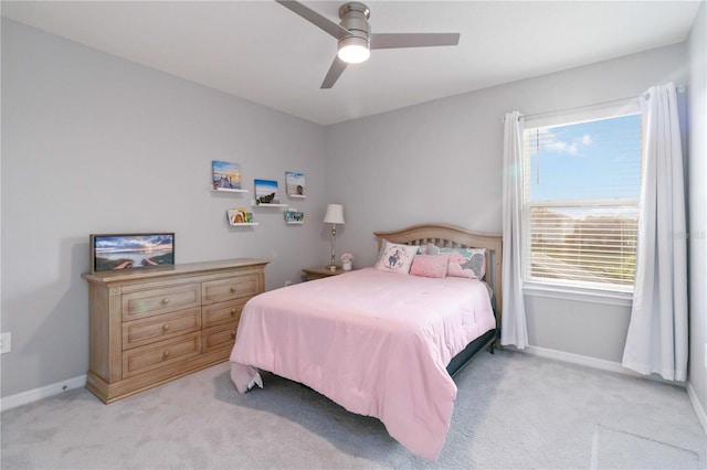 carpeted bedroom featuring ceiling fan and multiple windows