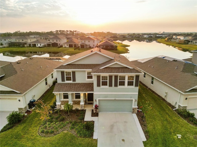 aerial view at dusk with a water view