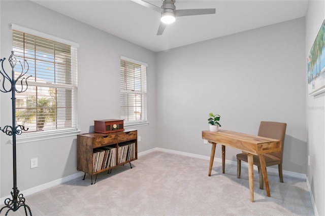 carpeted home office featuring ceiling fan