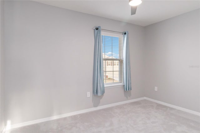 unfurnished room with ceiling fan and light colored carpet