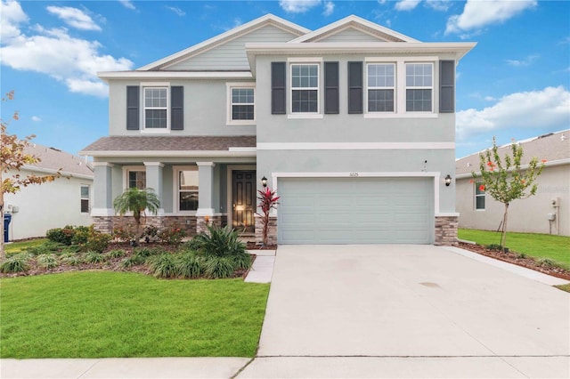 view of front of house featuring a garage and a front lawn