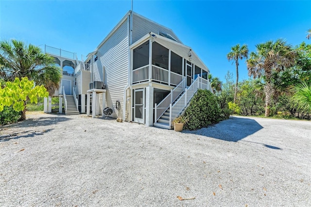 back of property with ceiling fan