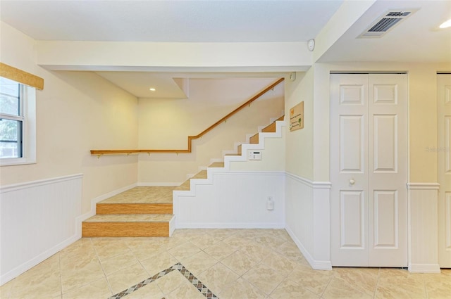 stairs with tile patterned floors