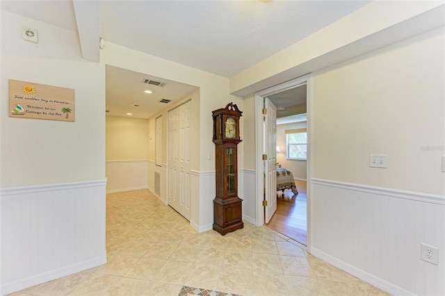 corridor featuring light tile patterned floors