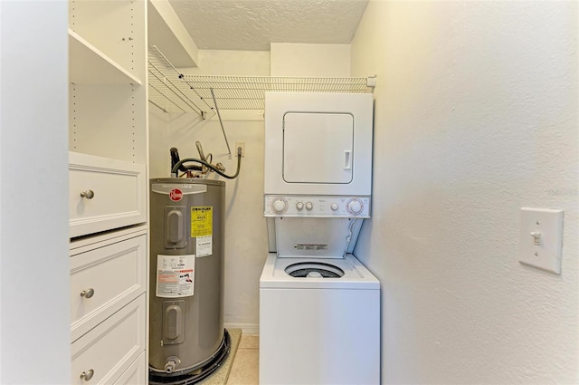 clothes washing area featuring light tile patterned flooring, stacked washing maching and dryer, a textured ceiling, and water heater