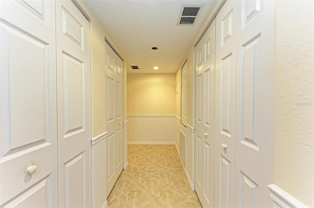 hall featuring light tile patterned floors