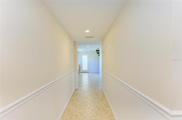 hall featuring light tile patterned floors