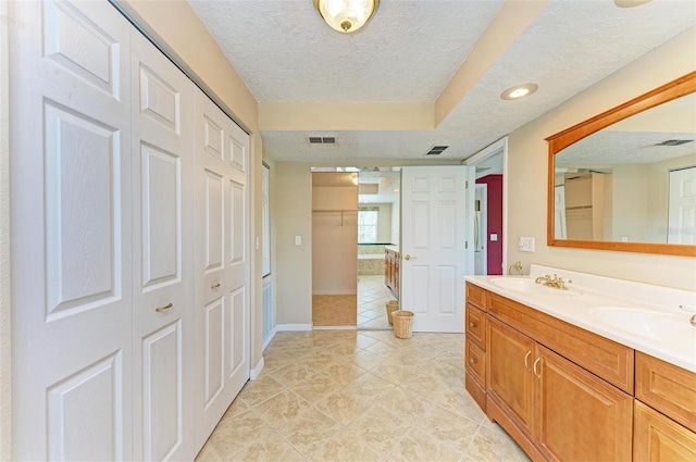 bathroom with a textured ceiling and vanity