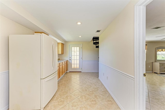 kitchen featuring white fridge and light tile patterned flooring