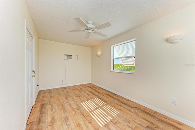 spare room with a textured ceiling, light hardwood / wood-style flooring, and ceiling fan