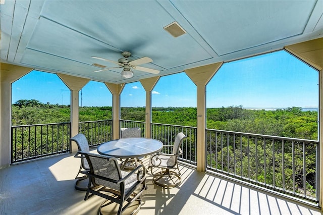 exterior space with ceiling fan and a balcony