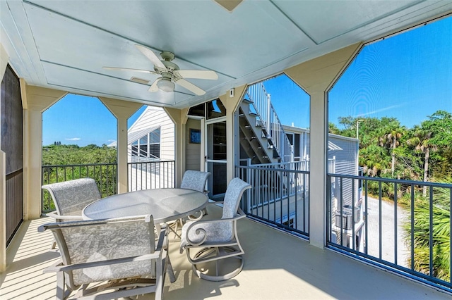 sunroom / solarium with a wealth of natural light and ceiling fan