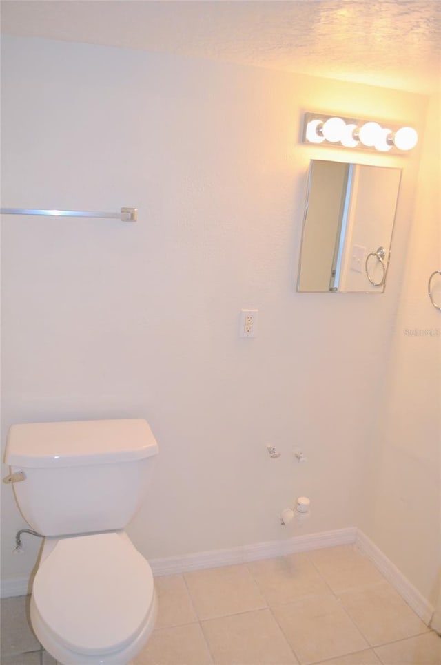 bathroom with tile patterned flooring and toilet