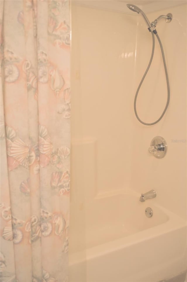 bathroom with shower / bath combination with curtain