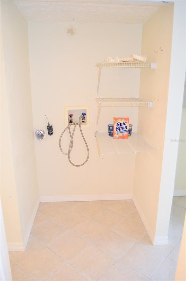 laundry area with tile patterned floors and washer hookup