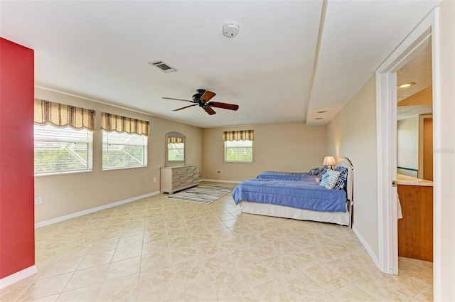 bedroom with ceiling fan and multiple windows