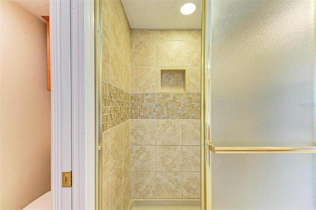 bathroom with a shower with door