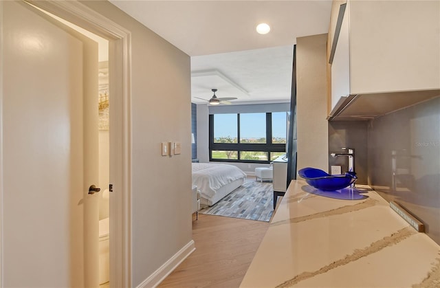 hall with light hardwood / wood-style floors and sink