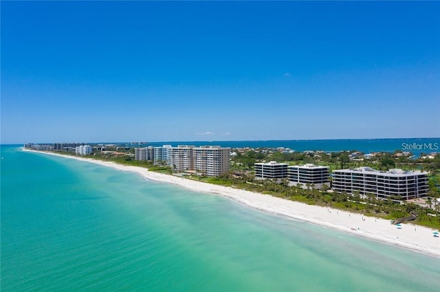 drone / aerial view featuring a water view and a view of the beach