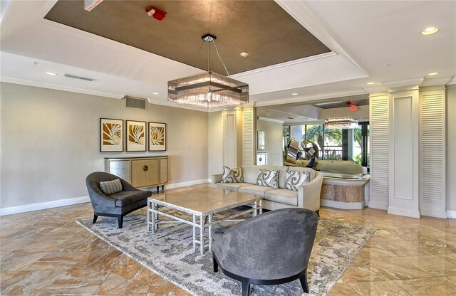 living room with a raised ceiling and crown molding