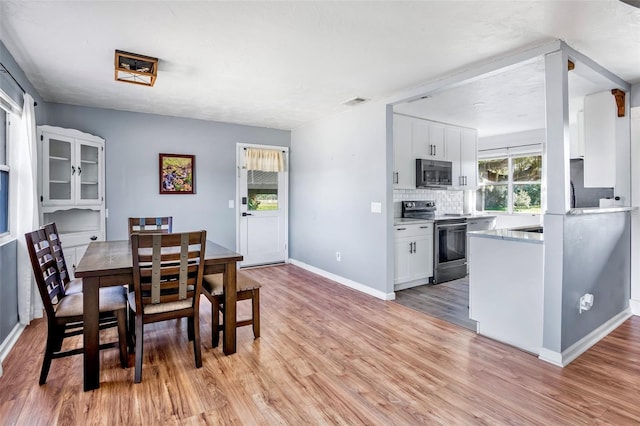 dining area with light wood-type flooring