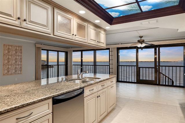 kitchen with stainless steel dishwasher, a water view, sink, and ornamental molding