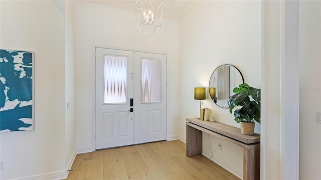 entryway featuring a notable chandelier and light wood-type flooring