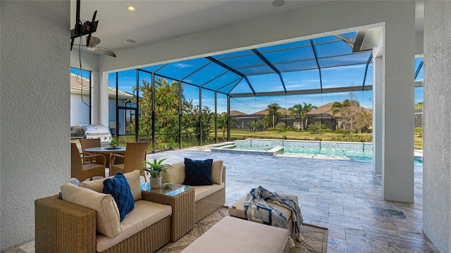 view of patio with ceiling fan, outdoor lounge area, glass enclosure, area for grilling, and an in ground hot tub