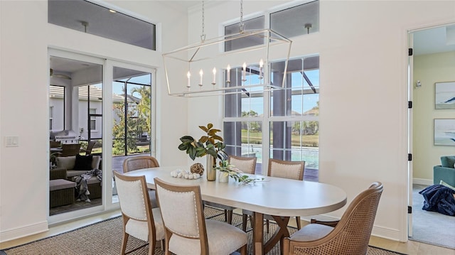 dining space featuring hardwood / wood-style floors and a notable chandelier