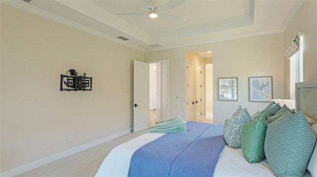 carpeted bedroom with a raised ceiling, crown molding, and ceiling fan