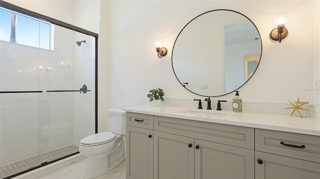 bathroom with vanity, an enclosed shower, and toilet