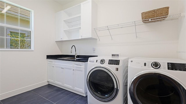 laundry area featuring sink, cabinets, and washer and dryer