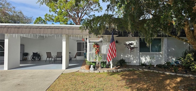 view of front of property featuring stucco siding and a patio