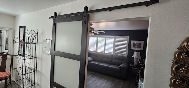 interior space featuring a barn door and dark hardwood / wood-style flooring