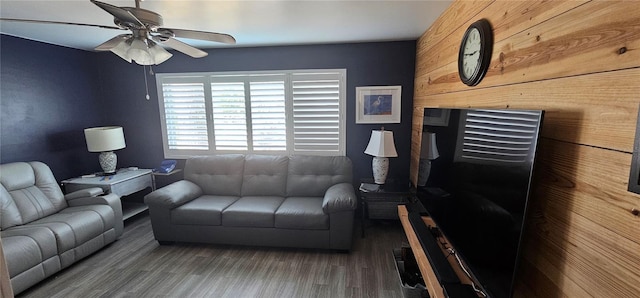 living room featuring ceiling fan and wood-type flooring