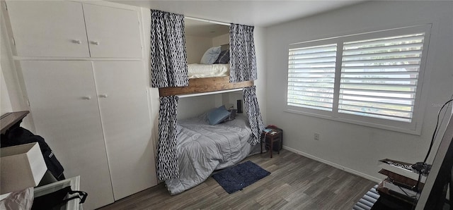 bedroom with dark hardwood / wood-style floors