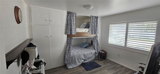 bedroom with dark wood-type flooring