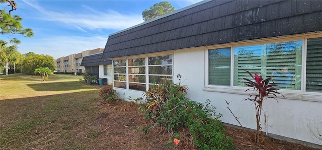 view of side of property with a lawn