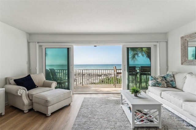 living room with a water view and hardwood / wood-style flooring