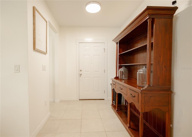 hall with light tile patterned floors