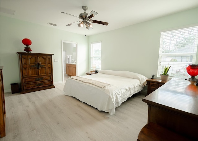 bedroom with light hardwood / wood-style floors, ceiling fan, and ensuite bathroom