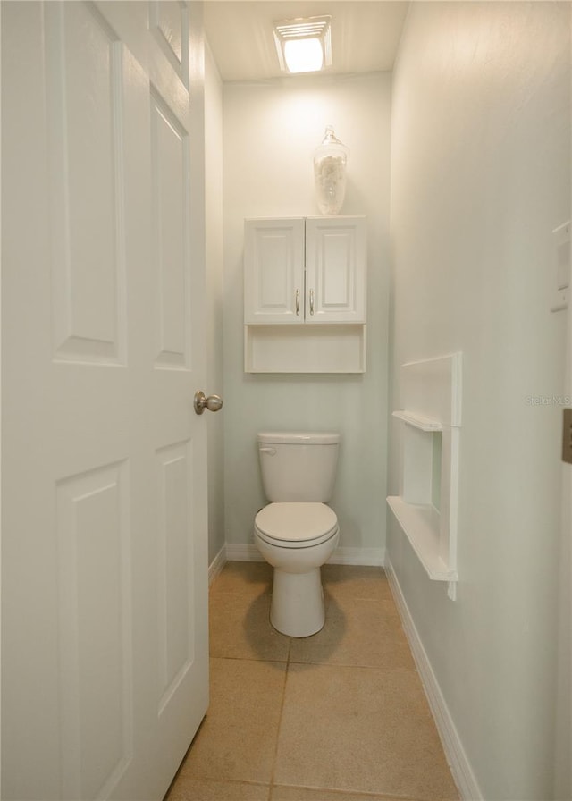 bathroom featuring tile patterned flooring and toilet