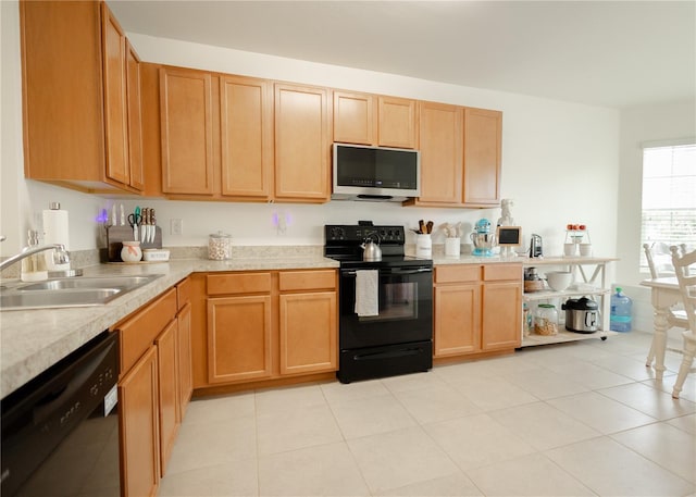 kitchen with light tile patterned floors, sink, and black appliances