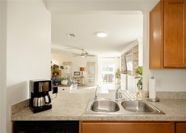 kitchen with ceiling fan, black dishwasher, and sink