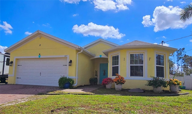 ranch-style home with a garage and a front yard