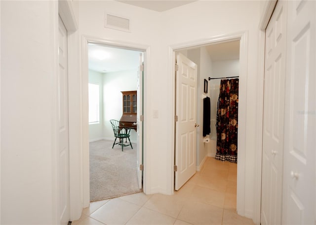 1877 Dragonfly Ave, North Port, FL 34288 - corridor with light tile patterned flooring and baseboards